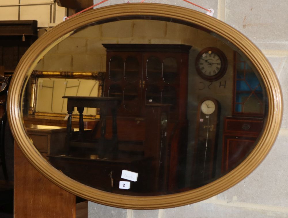 An oval giltwood bevelled wall mirror, W.96cm, H.65cm